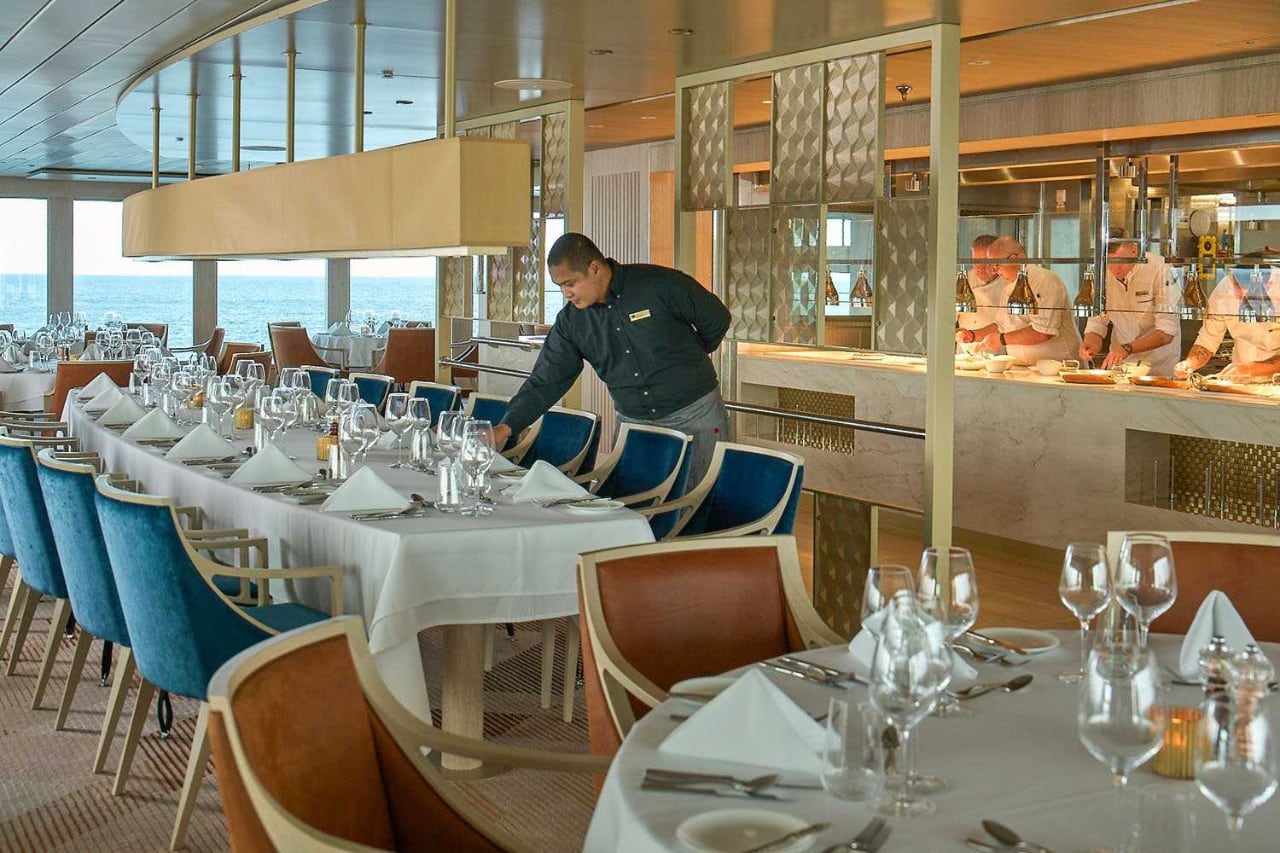 a man setting up a table in a restaurant