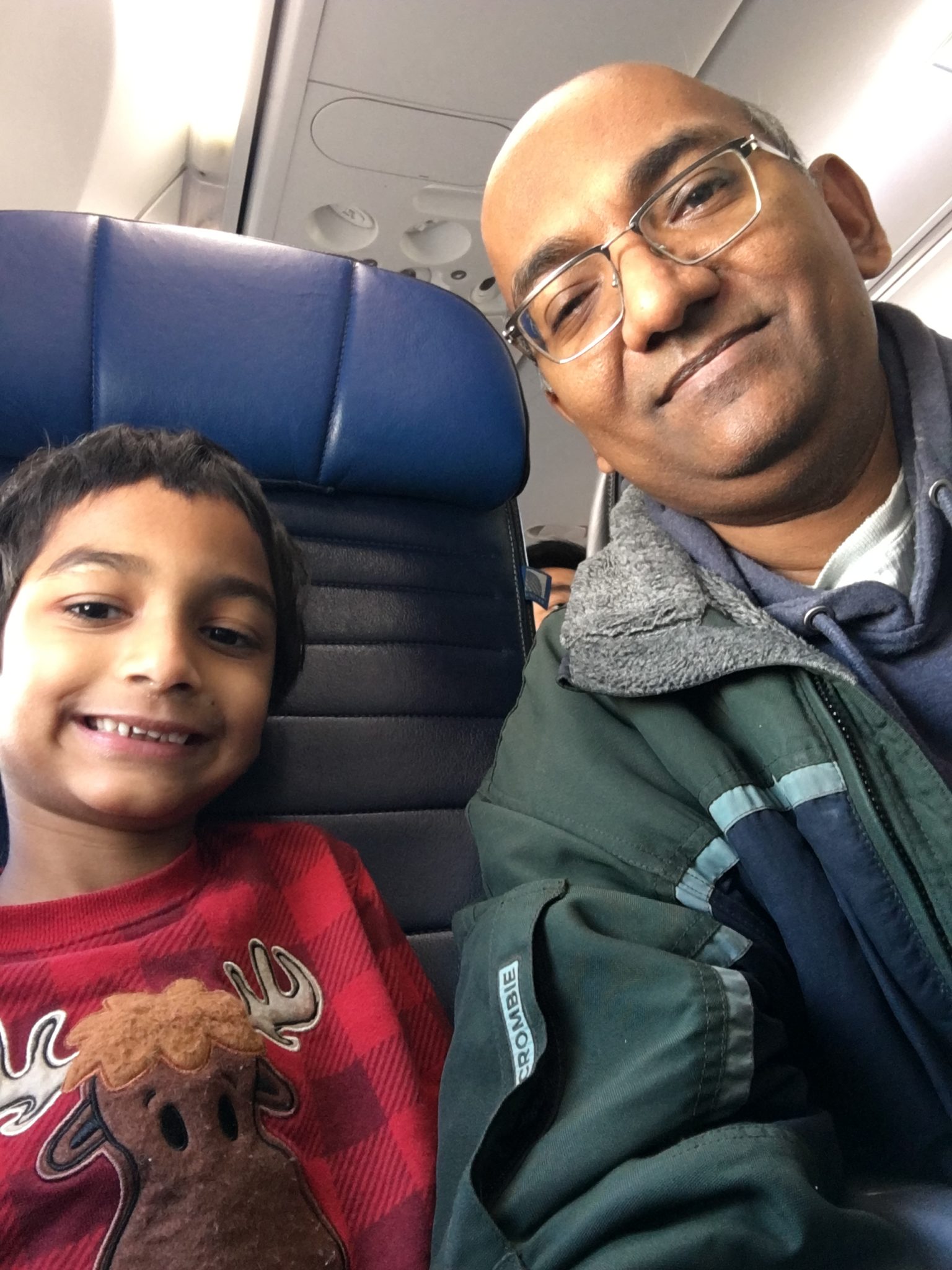 Father-son selfie in United economy class