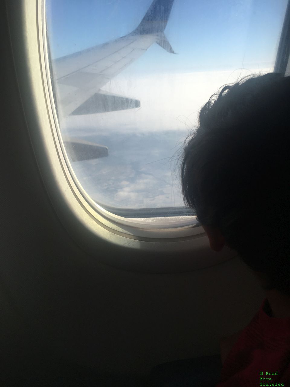 Young avgeek staring out the window