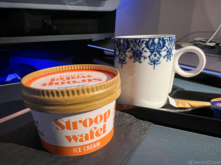 a cup of ice cream and a mug on a tray