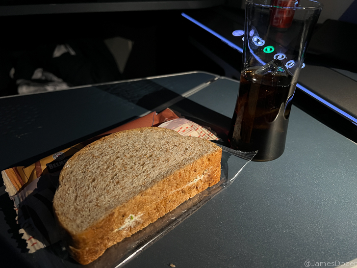 a sandwich and a glass of soda on a table