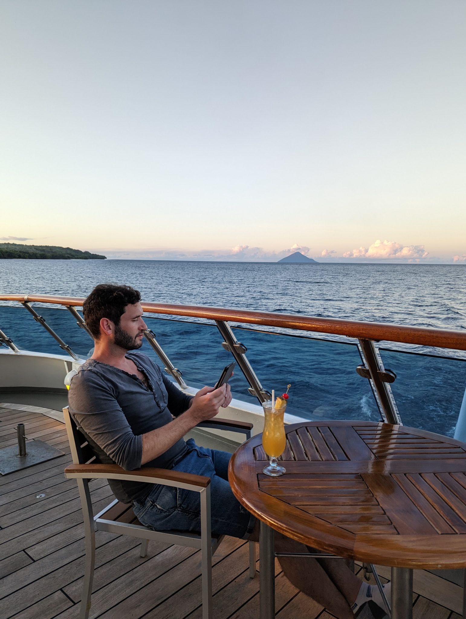 a man sitting at a table on a boat