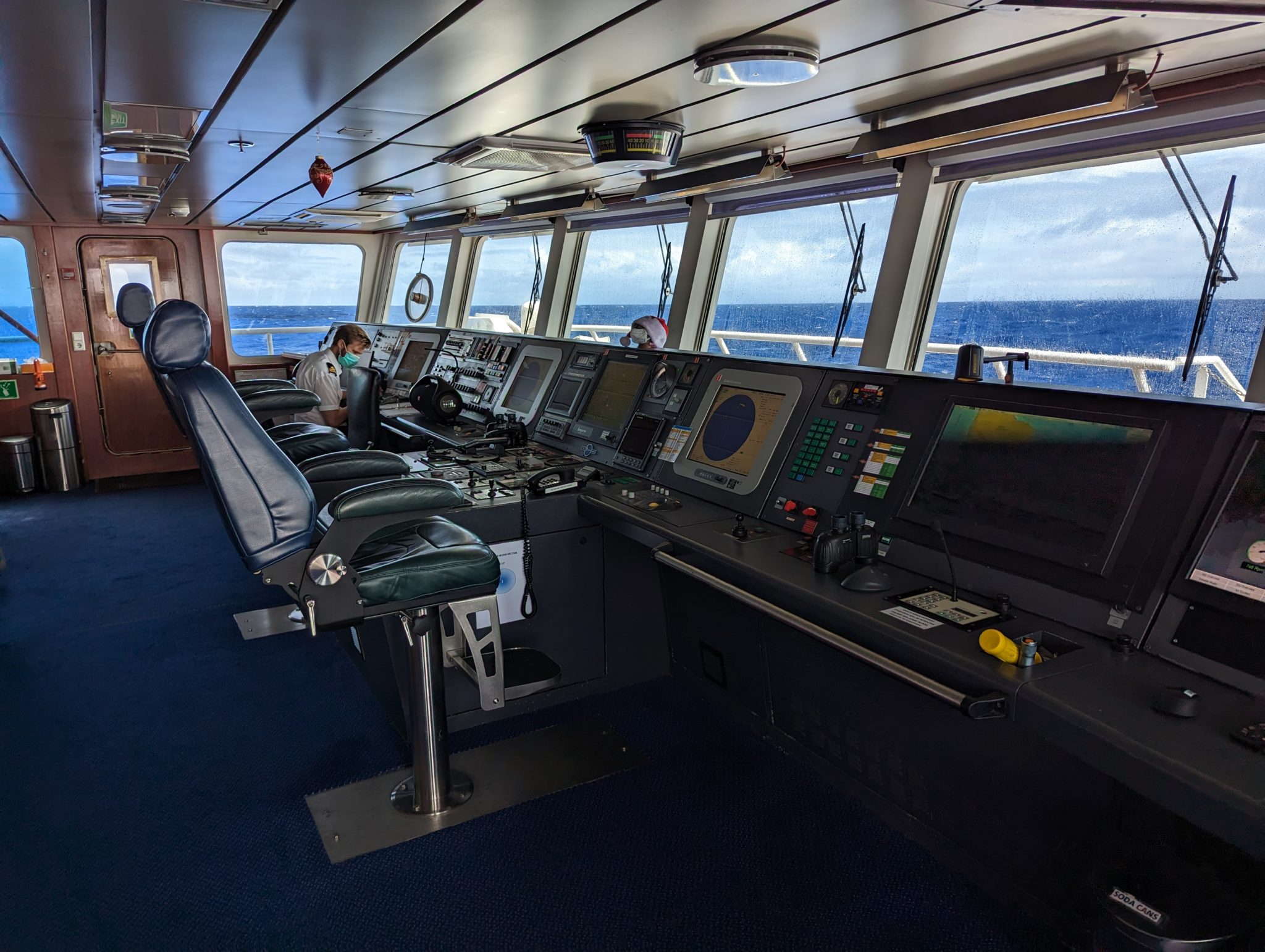 a control room with a person in the back