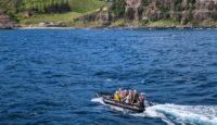 a group of people in a boat on the water