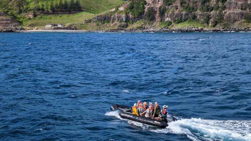 a group of people in a boat on the water