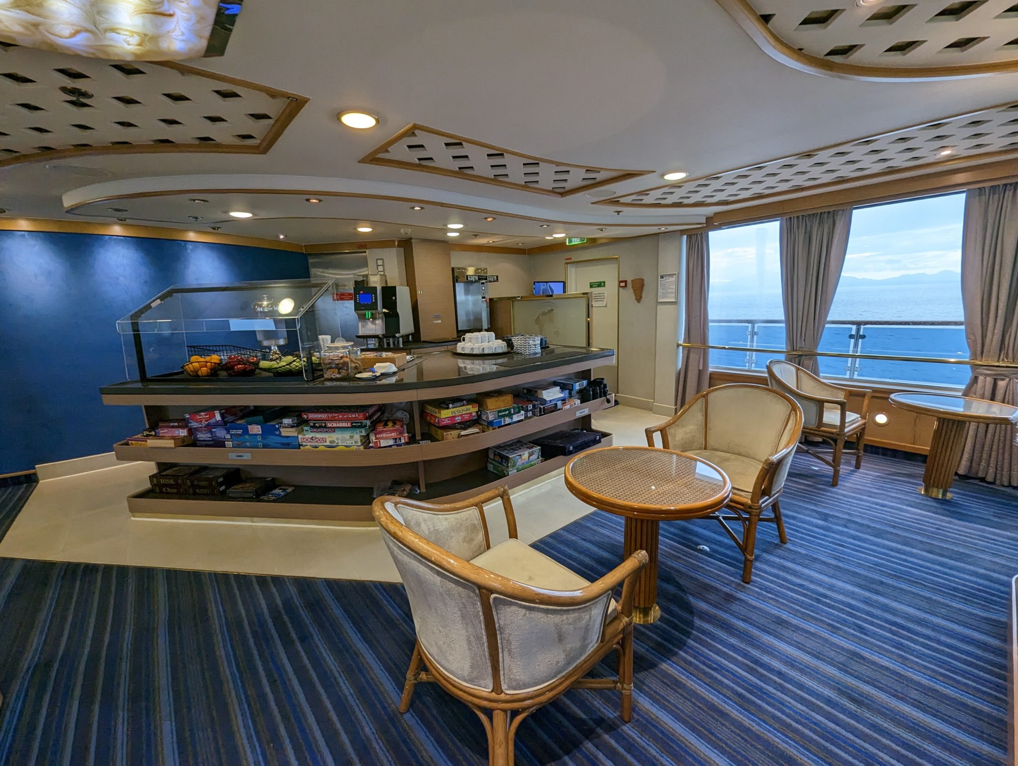a room with a table and chairs and a glass display case