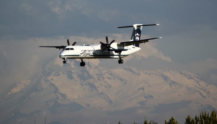 a plane flying over mountains
