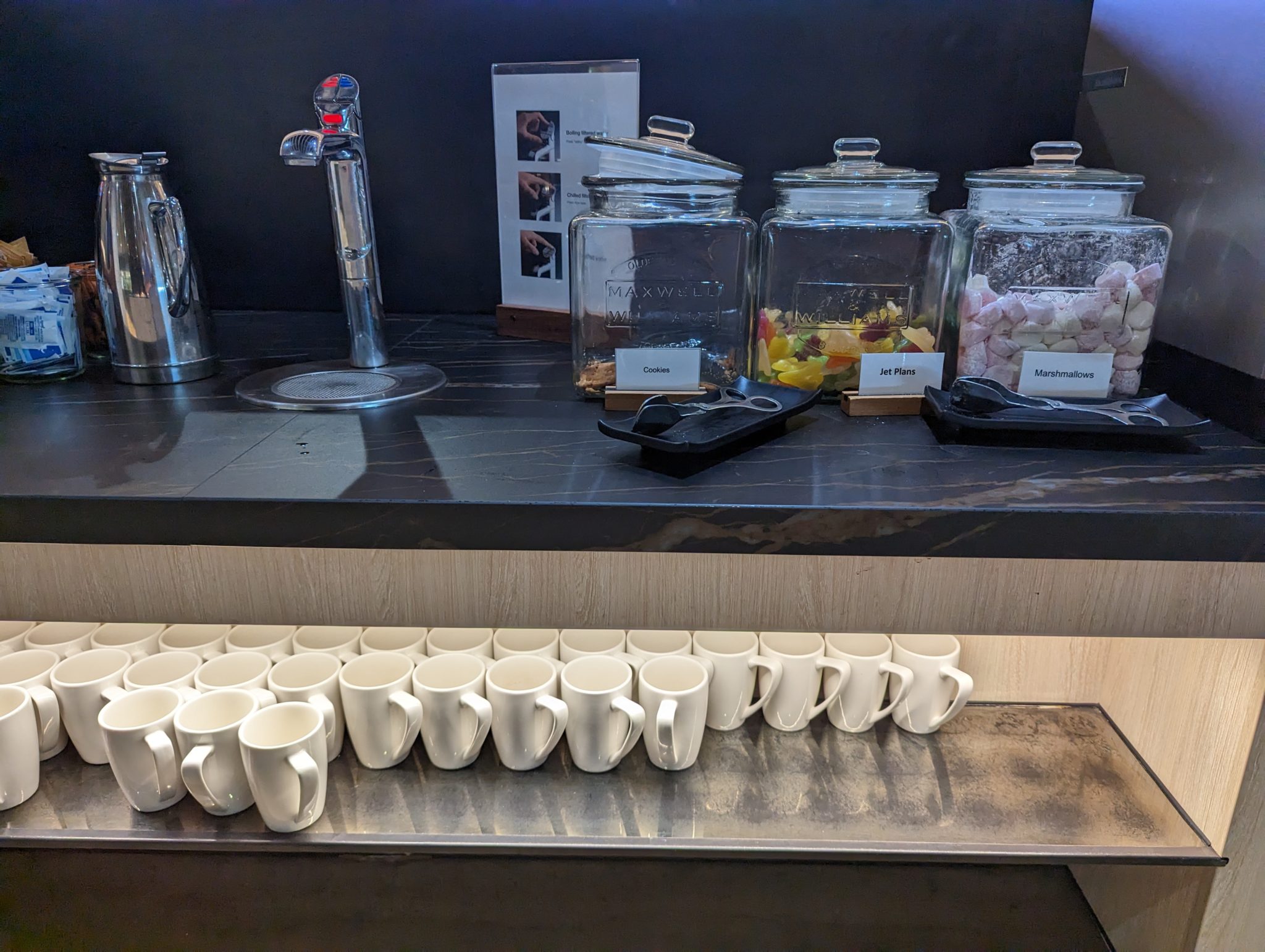 a row of white mugs on a counter