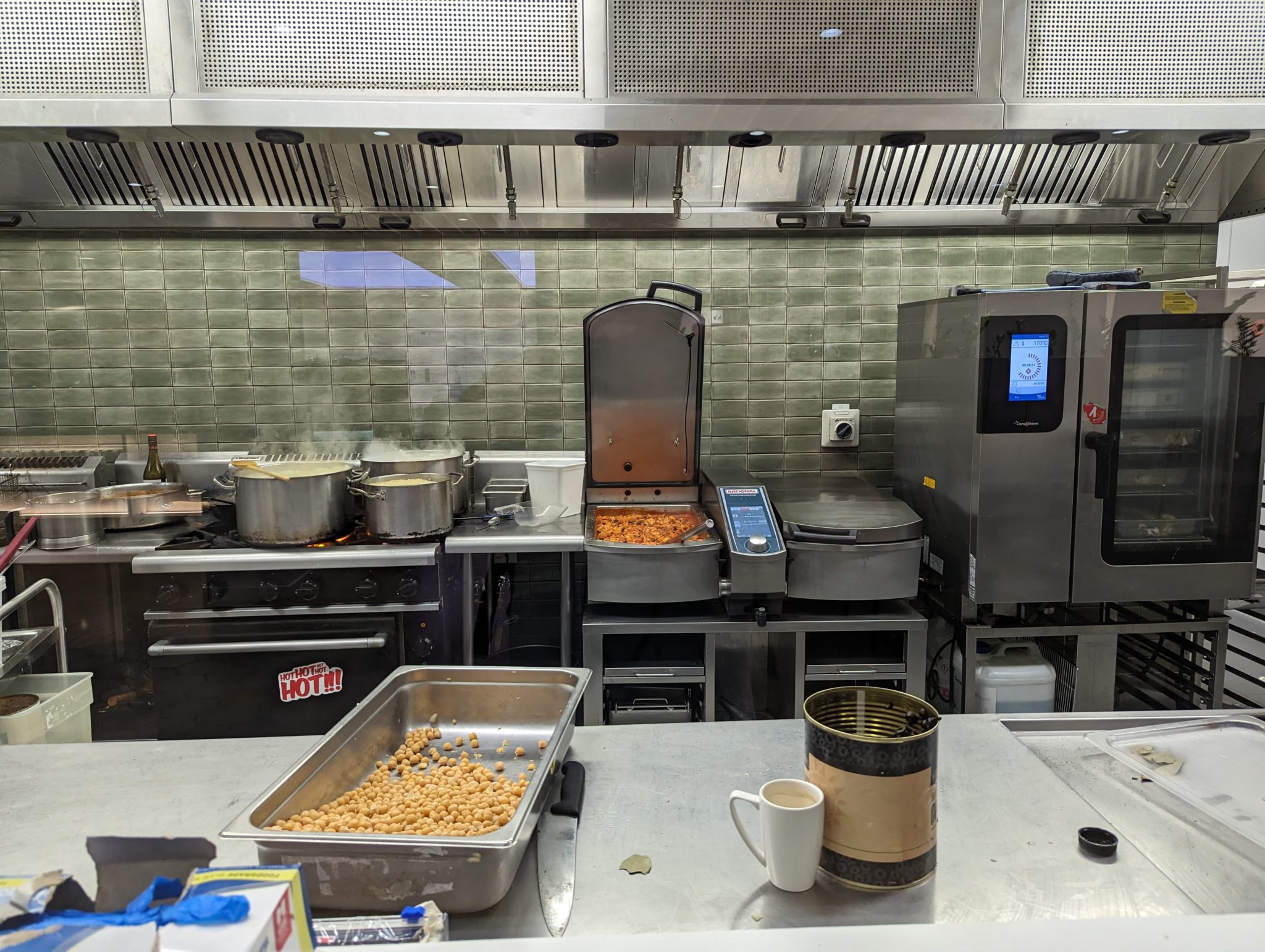 a kitchen with a large counter and a large pan of food