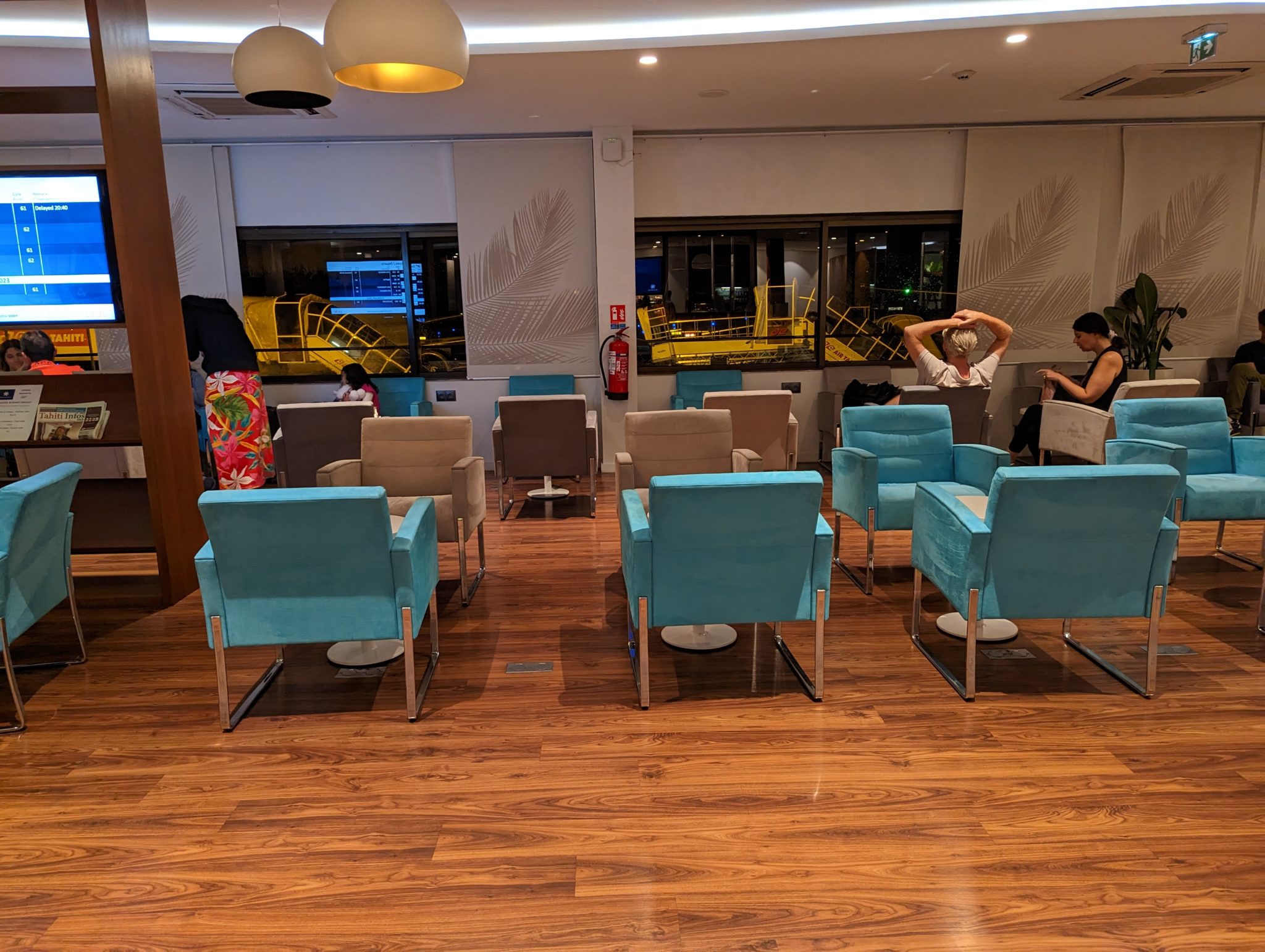 a room with blue chairs and a wood floor