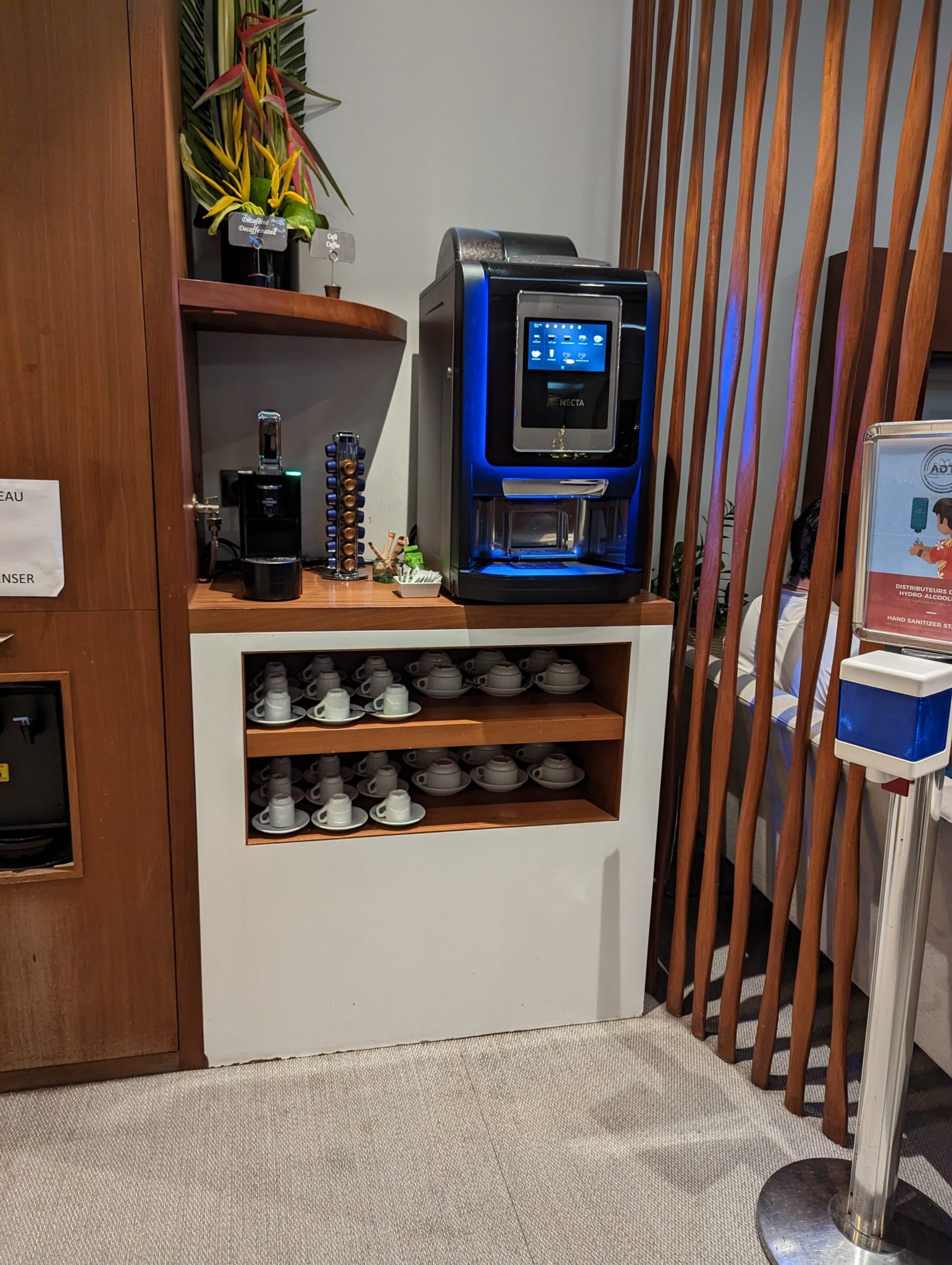 a coffee machine and cups on a shelf