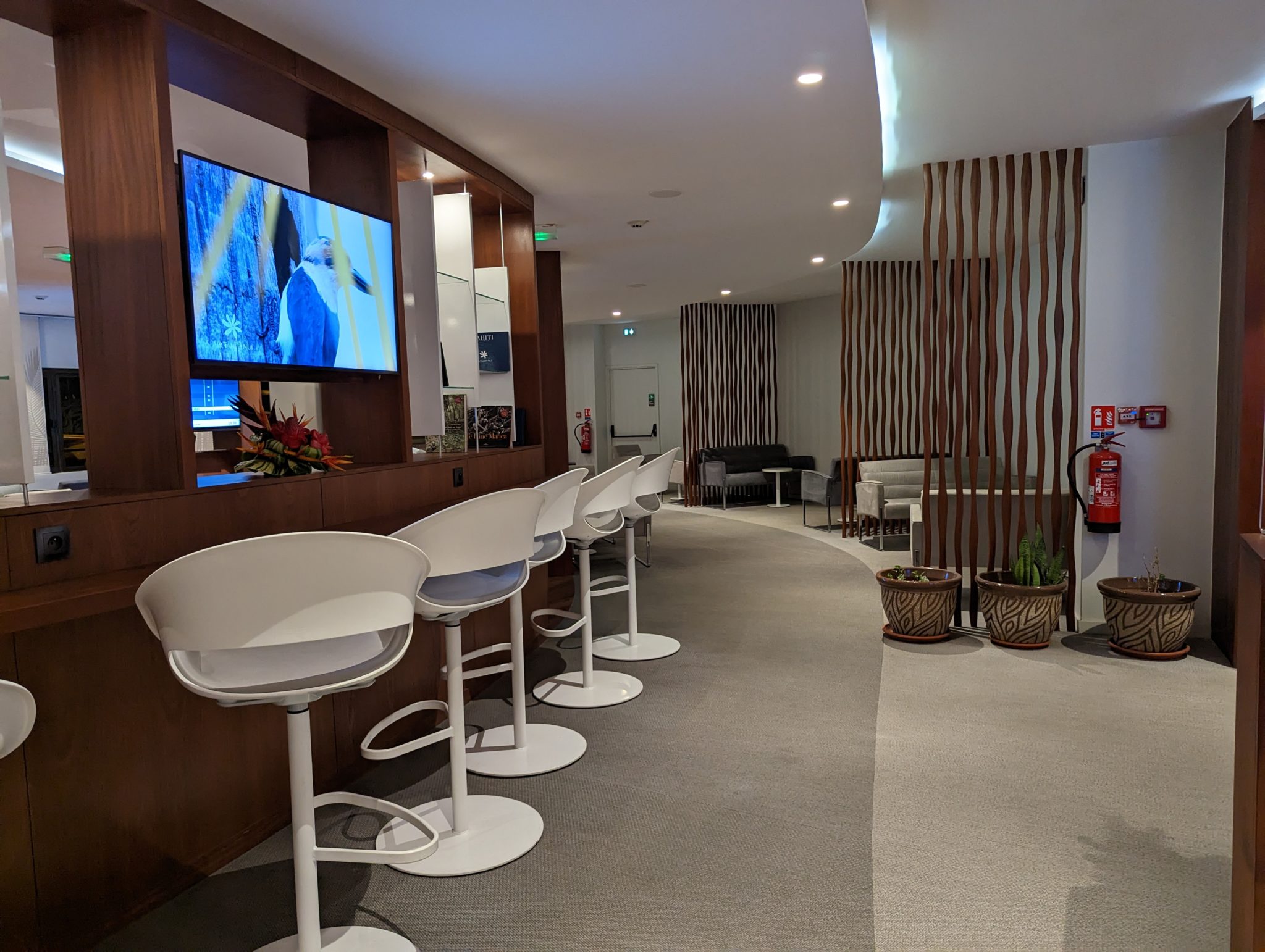 a room with white chairs and a television