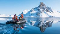 a group of people in a raft on water with a mountain in the background