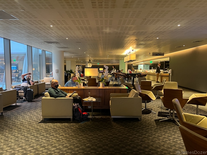 people sitting in chairs in a lobby