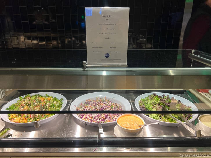a salads in bowls in a display case