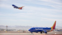 a blue and yellow airplane on a runway