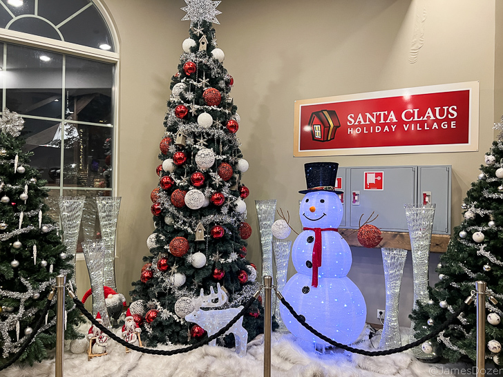 a christmas tree with lights and snowman