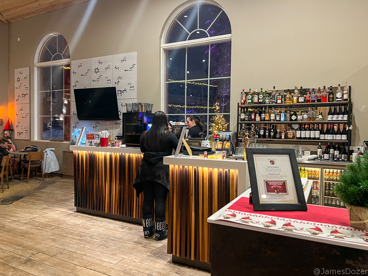 a woman standing at a counter in a bar