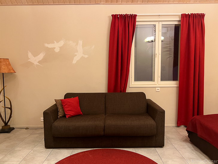 a couch in a room with red curtains