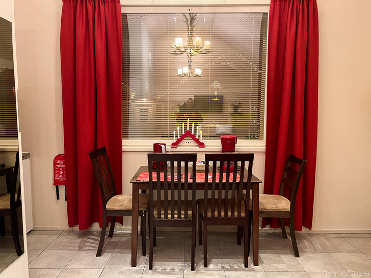 a table and chairs in front of a window