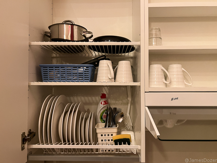 a shelf with dishes and utensils