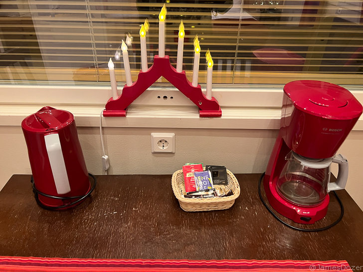 a coffee maker and a basket of candies and a basket of candies