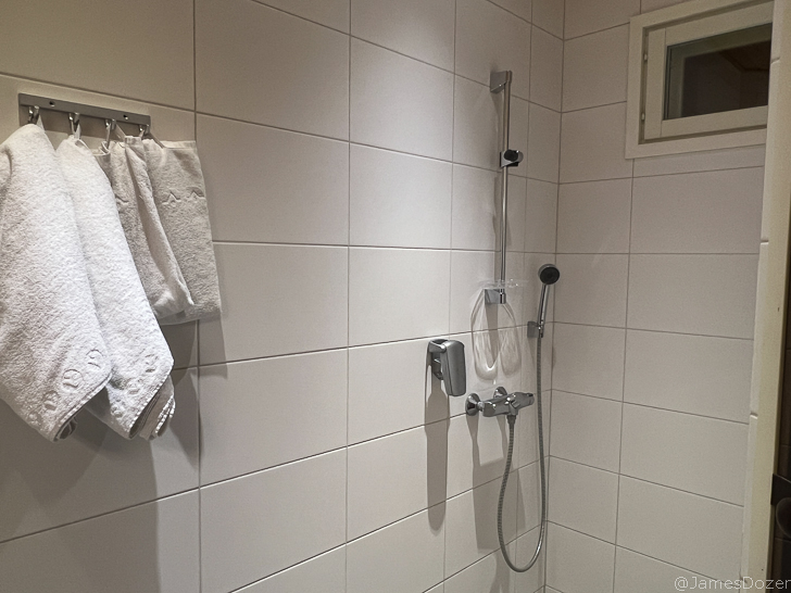 a shower with a shower head and a shower head