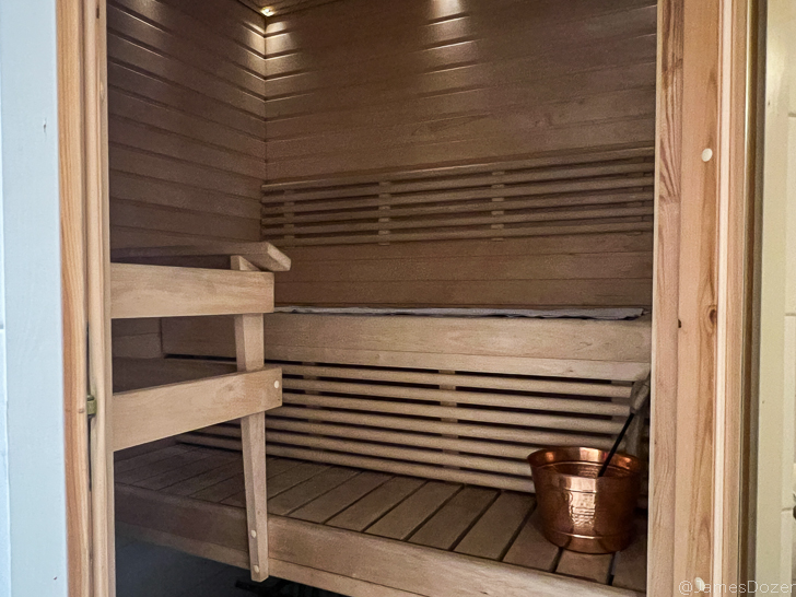 a wooden sauna with a bucket and a bucket