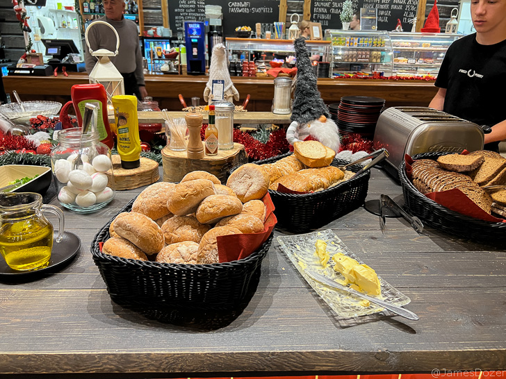 a table with baskets of bread and other food items