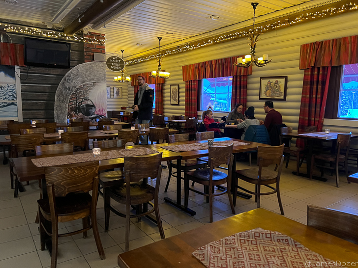a group of people sitting at tables in a restaurant