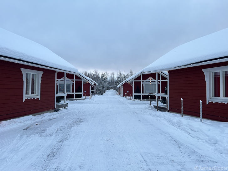 a row of red houses with snow on the ground