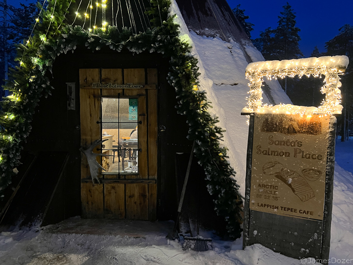 a wooden door with a sign and lights on it