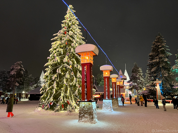 a group of lights and a tree in the snow