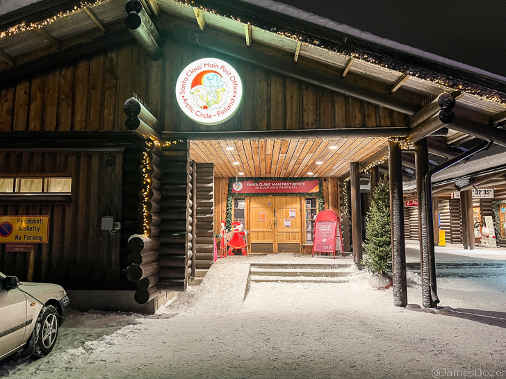 a building with a sign and a snow covered ground