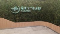 a green wall with a sign on it