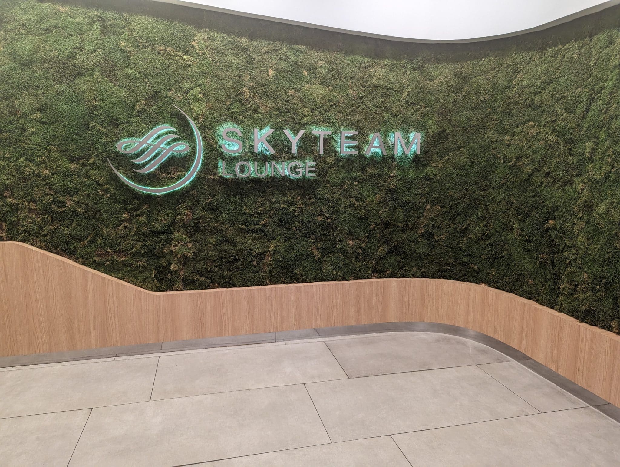 a green wall with a sign on it