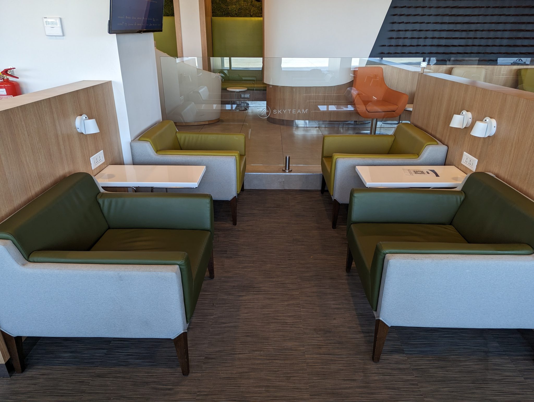 a room with green chairs and tables