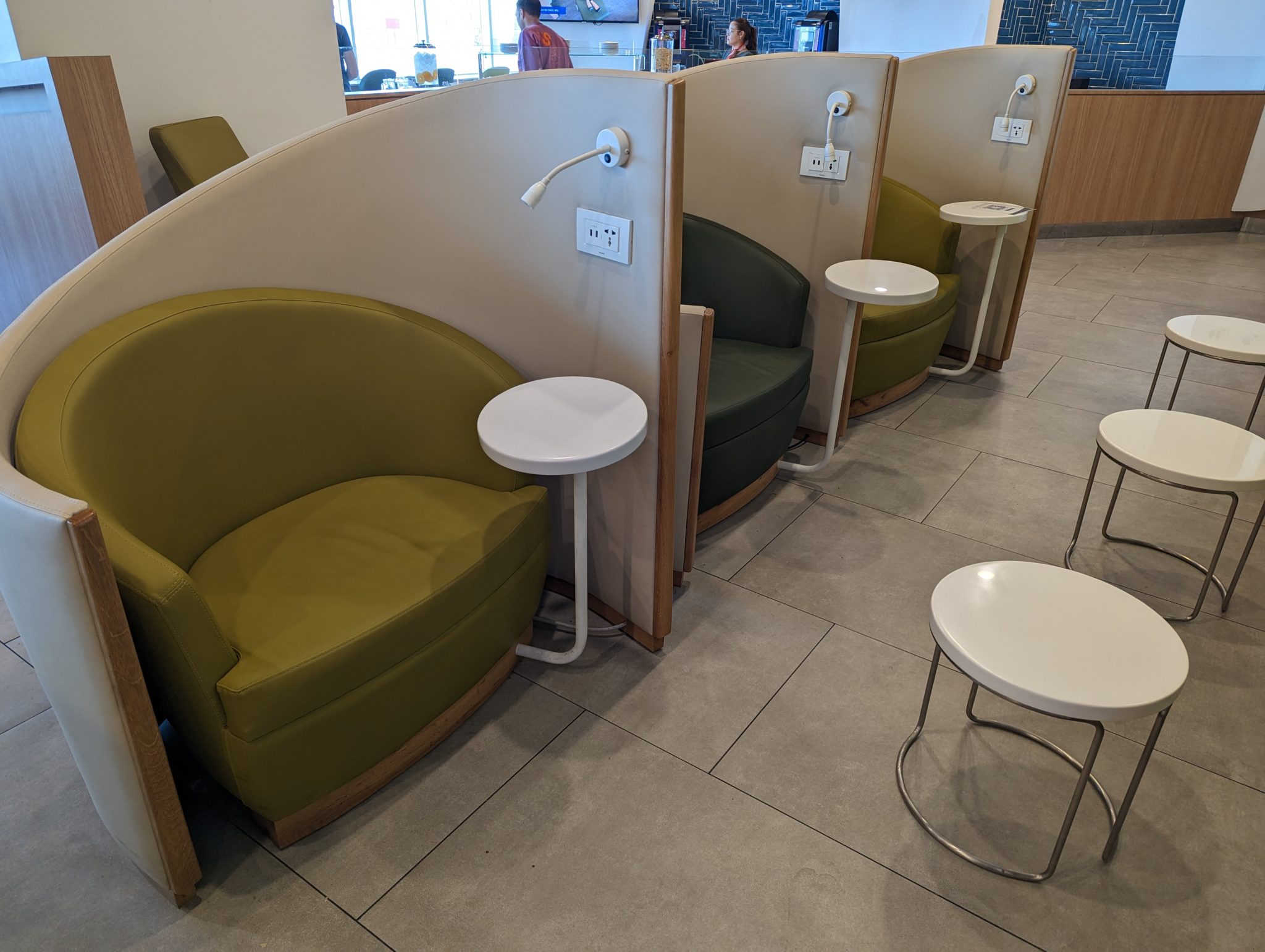 a green and white chairs and a white table