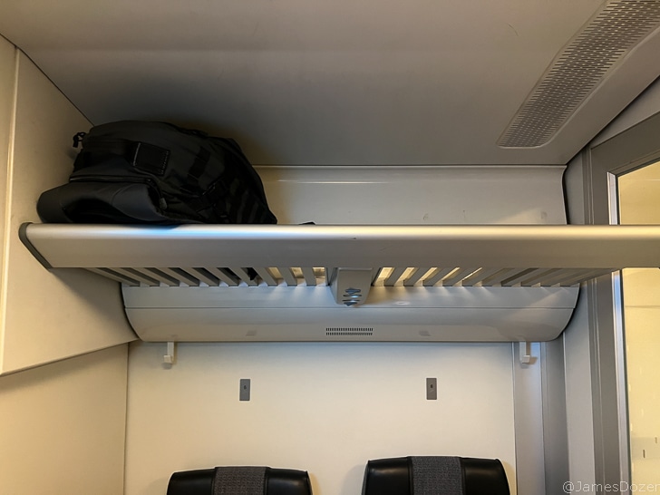 a black bag on a shelf in a white room