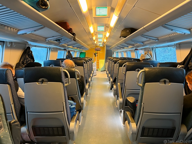 a train with seats and a person sitting on it