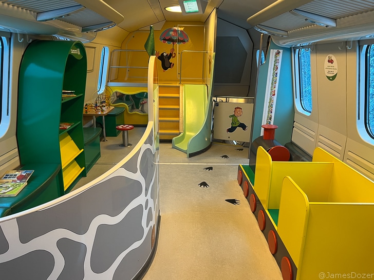 a room with a slide and a train