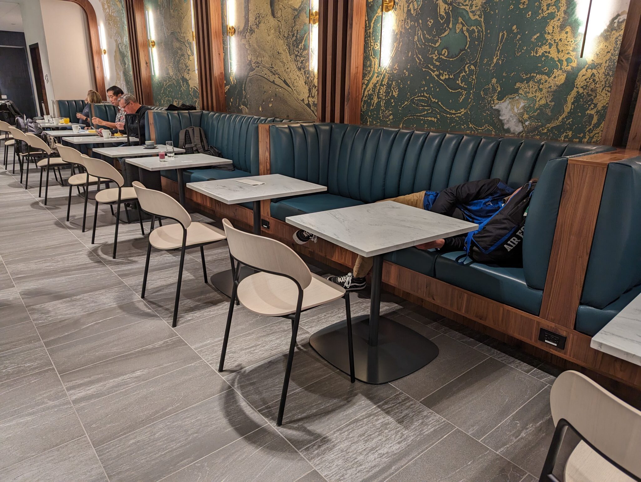 a group of people sitting at tables in a booth