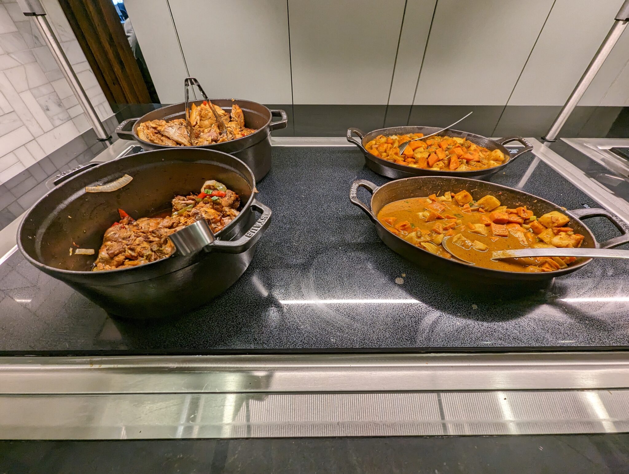 a group of pots of food on a stove