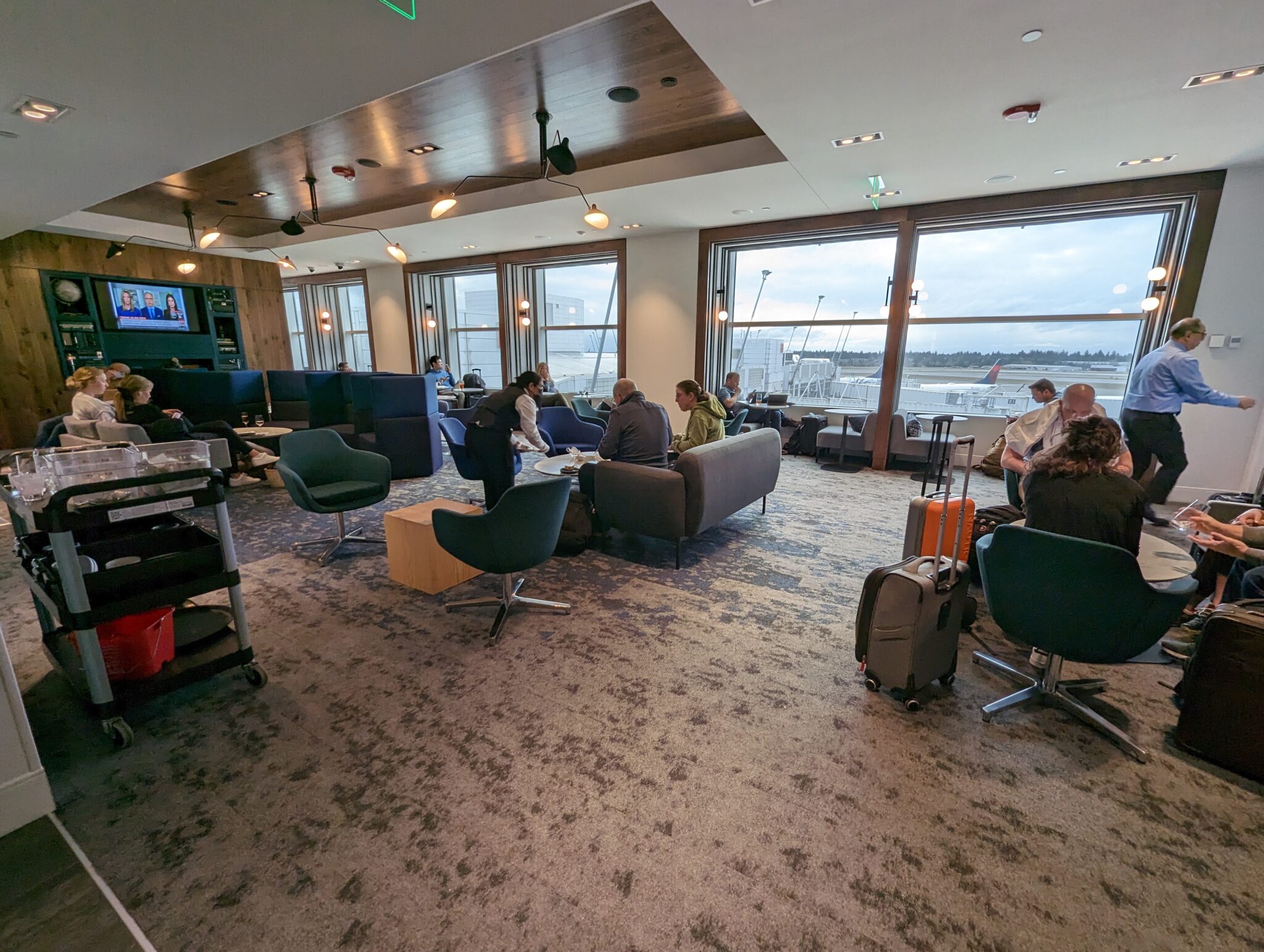 people sitting in a room with chairs and a television