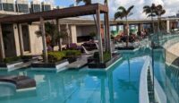 a pool with a deck and chairs