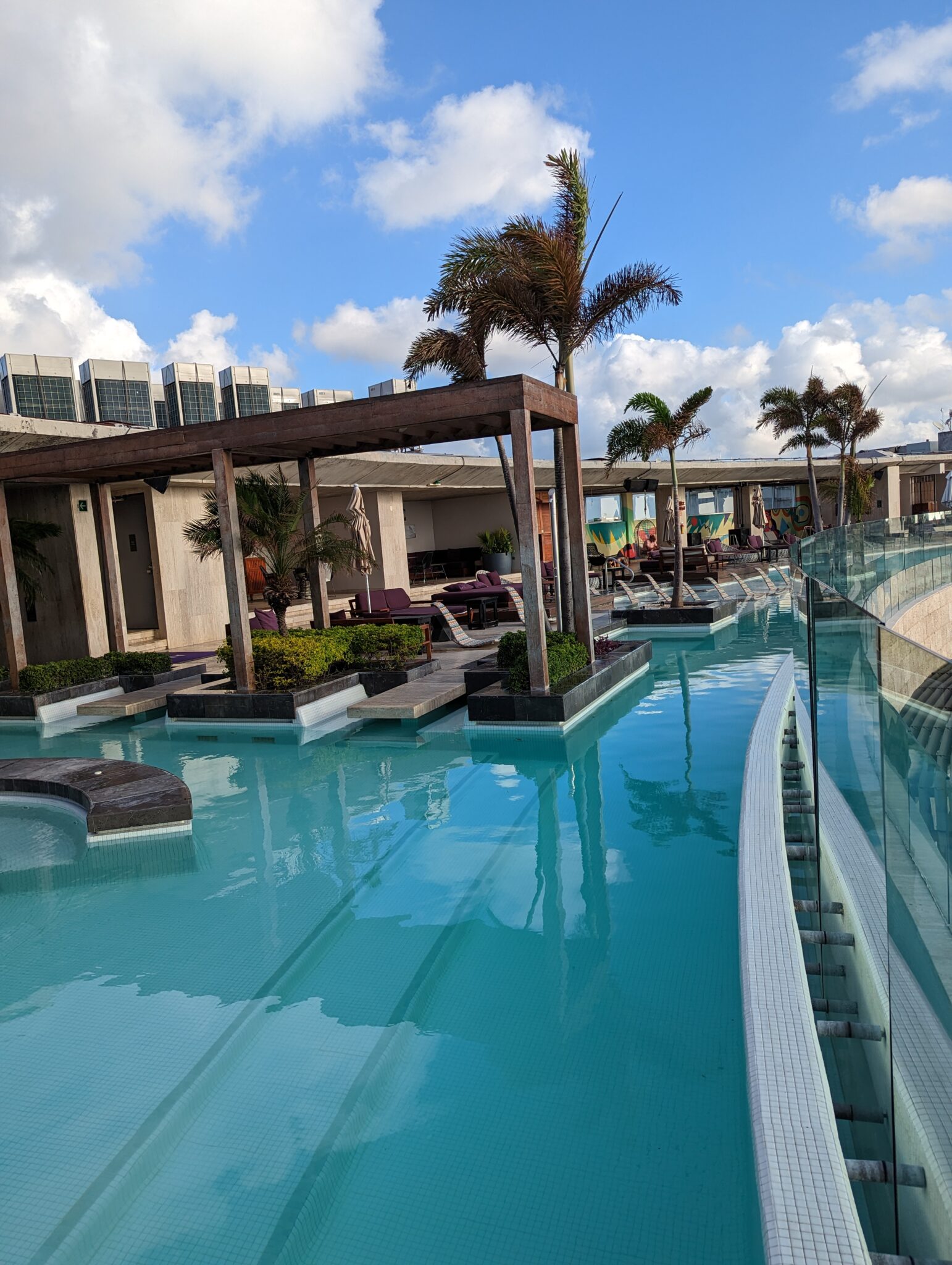 a pool with a deck and chairs