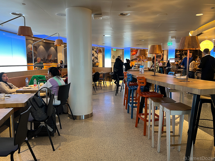 a group of people sitting at tables in a restaurant