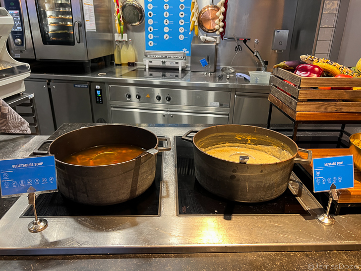 two large pots with soup on a stove
