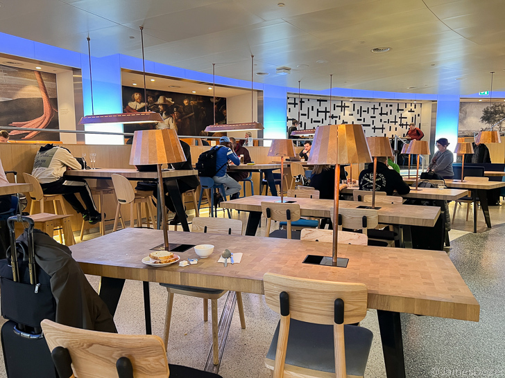 a group of people sitting at tables in a restaurant