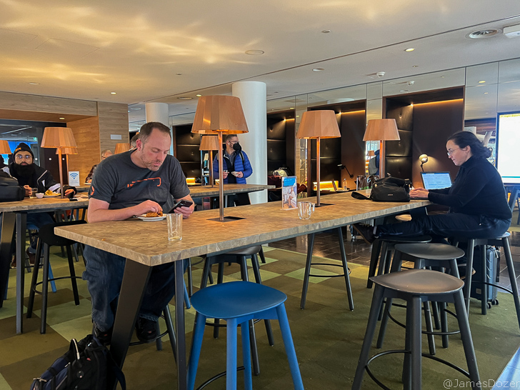 a man sitting at a table with a laptop